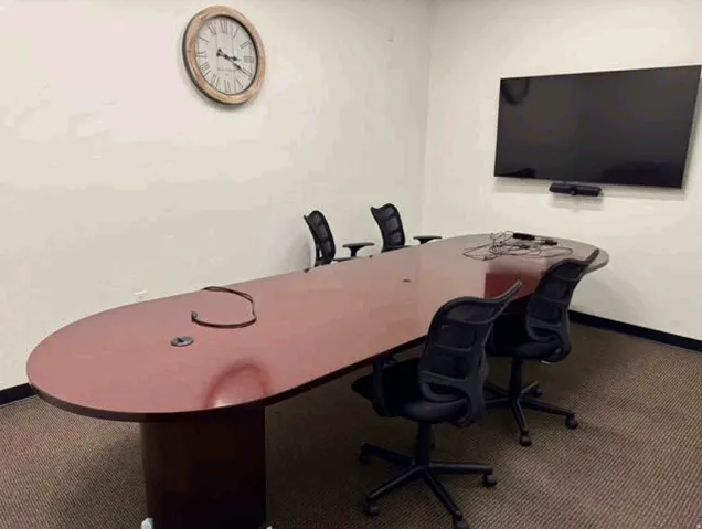 Wall-mounted display, integrated speaker bar, and carpeted flooring