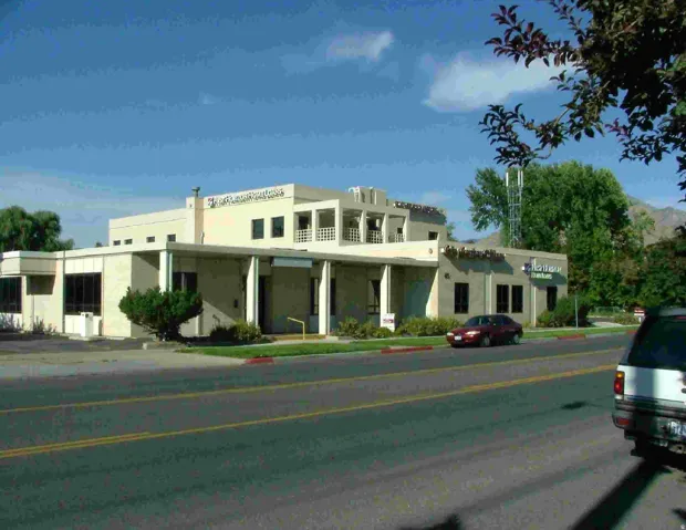 Two-story commercial building featuring stucco exterior and multiple window styles