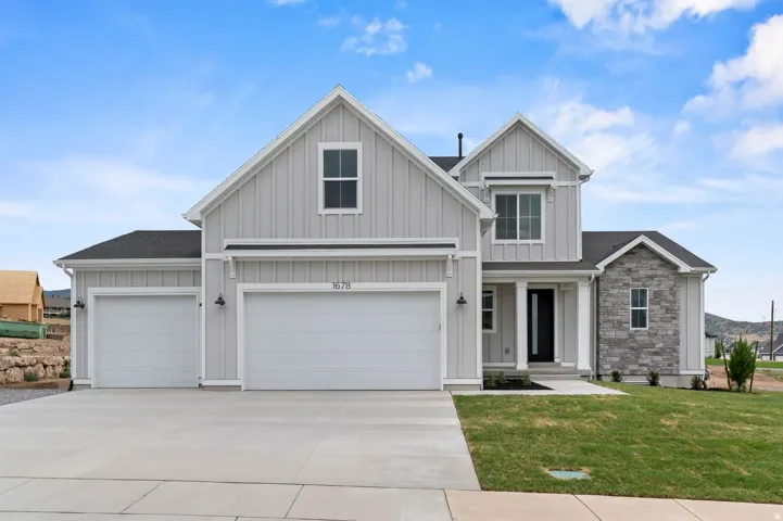 Modern farmhouse exterior with board and batten siding, stone facade accents, a three-car garage, and an inviting covered entry