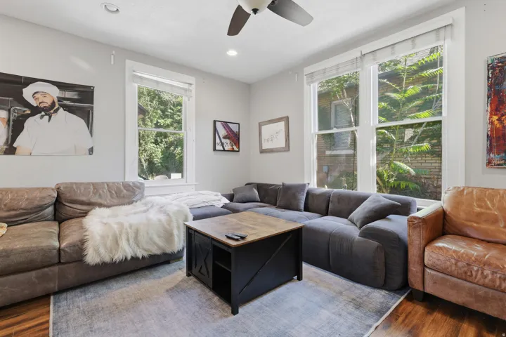 Recessed lighting, ceiling fan, multiple large windows, wood-finish flooring