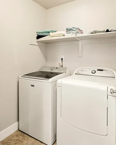 White shelving with support brackets, light-toned wall finish, and wood-finish flooring