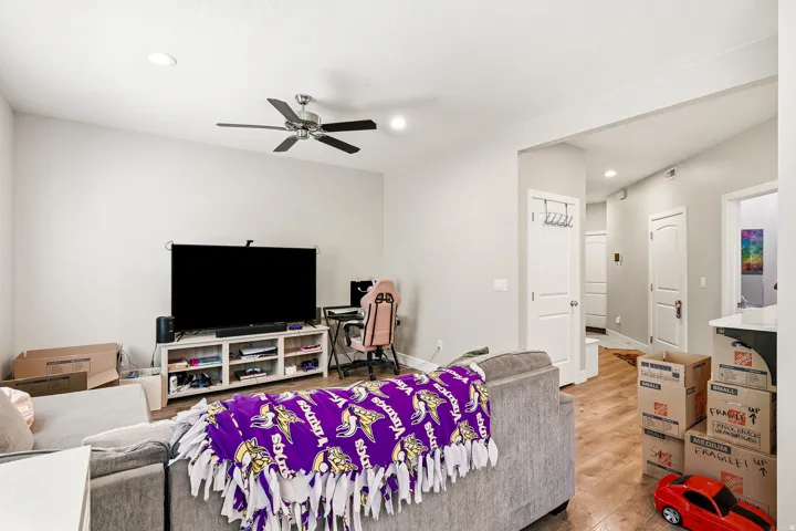 Recessed lighting, ceiling fan, wood-finish flooring, white paneled doors, and painted walls