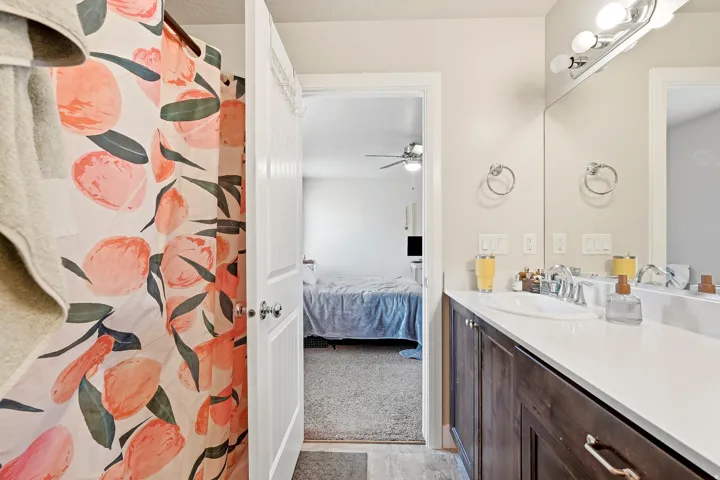 Integrated bathroom vanity with a white solid surface countertop, undermount sink, and chrome fixtures