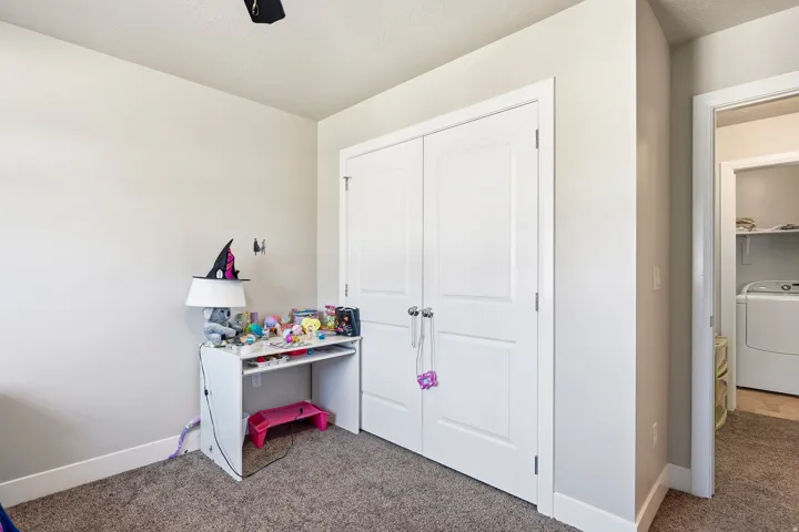 Neutral wall paint, white trim, and carpeted flooring