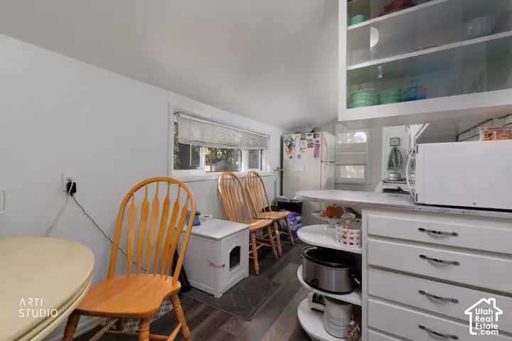 White cabinetry with glass-front upper storage