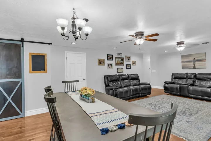 Open concept living area with wood-finish flooring