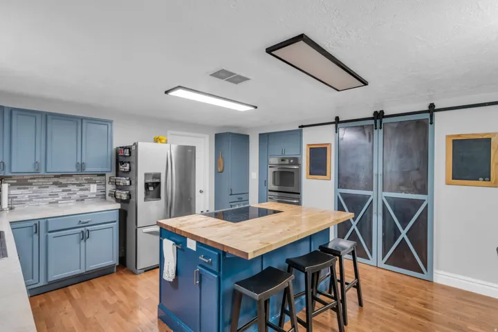 Wood-finish flooring complemented by blue cabinetry