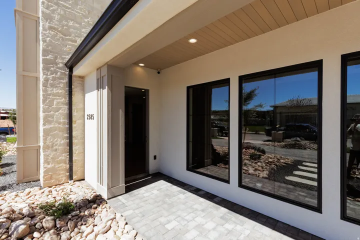 Stone veneer and stucco exterior with sleek black-framed windows