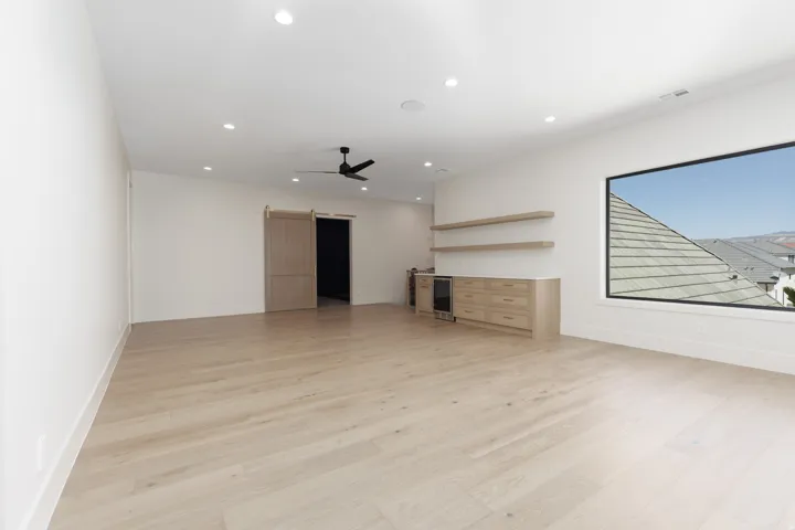Light wood-finish flooring with recessed lighting