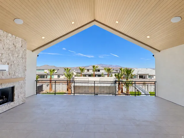 Covered patio featuring a slatted wood ceiling with recessed lighting and built-in speakers