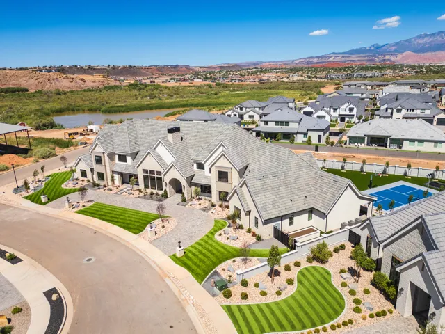 Expansive property with a multi-gabled roofline and a paver driveway