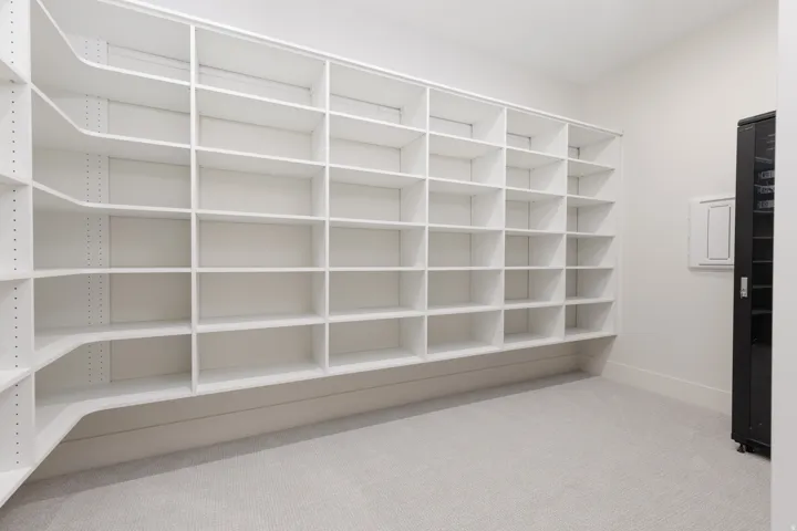 Built-in white shelving system with adjustable shelves