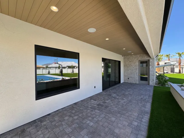 Covered patio featuring wood-finish ceiling, recessed lighting, and stone veneer wall accent