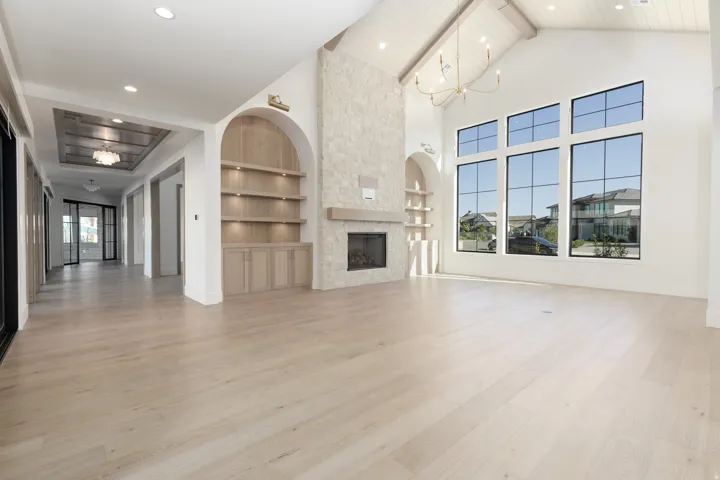 Vaulted ceiling with exposed beams and central chandelier