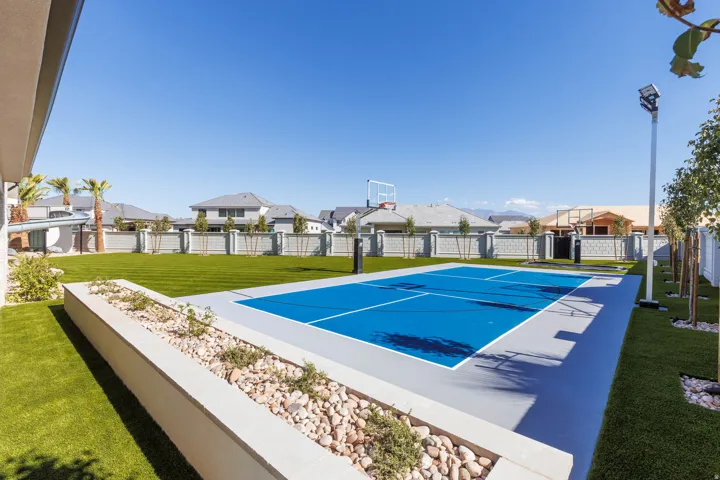 Outdoor multi-sport court featuring a vibrant blue surface