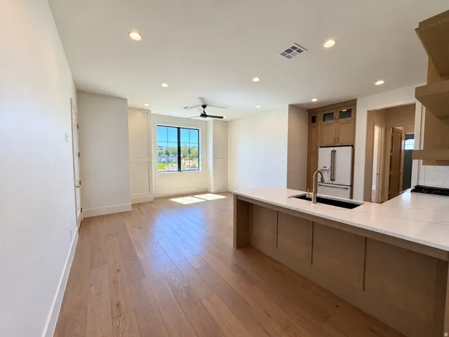 Wood-finish flooring, recessed lighting, and a ceiling fan