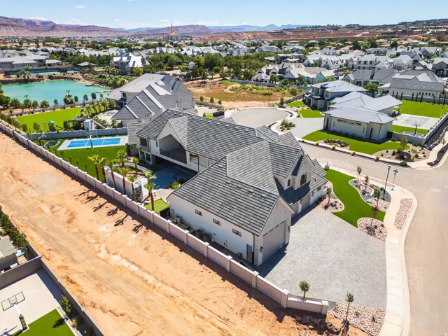 Expansive property featuring a multi-level structure, paved driveway, private pool, and pickleball court