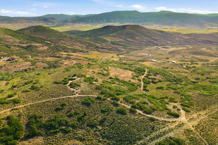Expansive mountain landscape with rolling hills and distant peaks