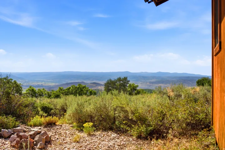 Expansive natural landscape with distant mountain ranges under a clear sky