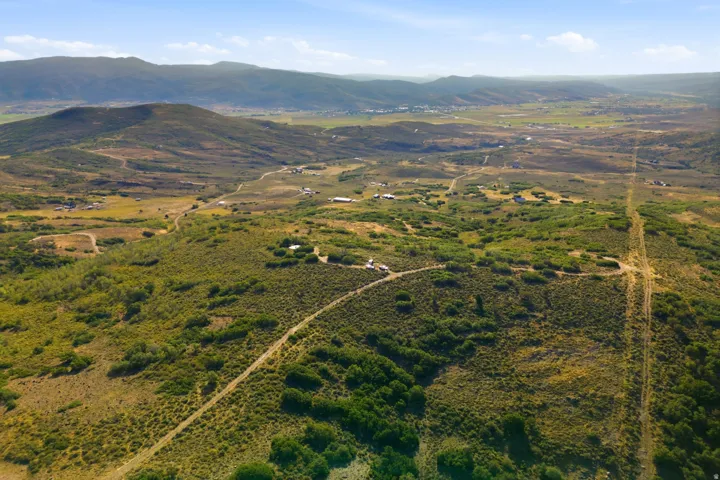 Expansive natural landscape featuring rolling hills and distant mountains