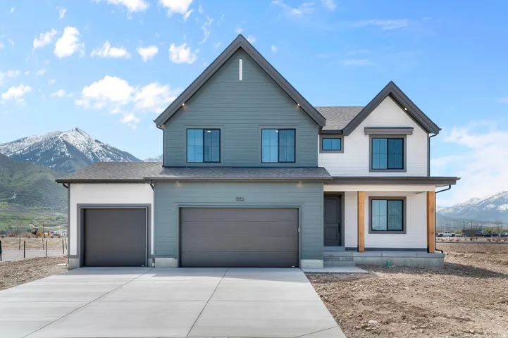 Contemporary exterior with horizontal siding, a two-car garage, and an additional single-car garage