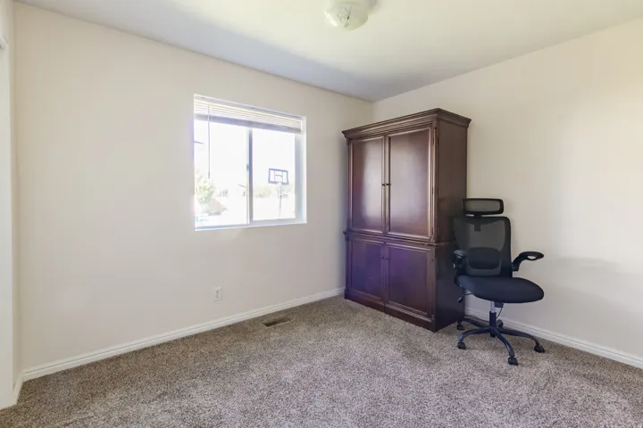 Neutral-toned walls complement plush carpeting