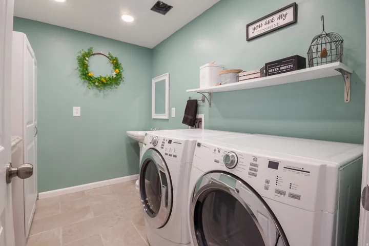Recessed lighting, wall-mounted shelving, and a pedestal sink