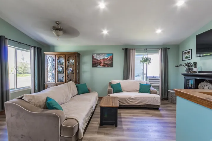 Recessed lighting, wood-finish flooring, ceiling fan, and multiple windows