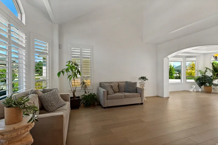 High vaulted ceilings complement the light wood-finish flooring
