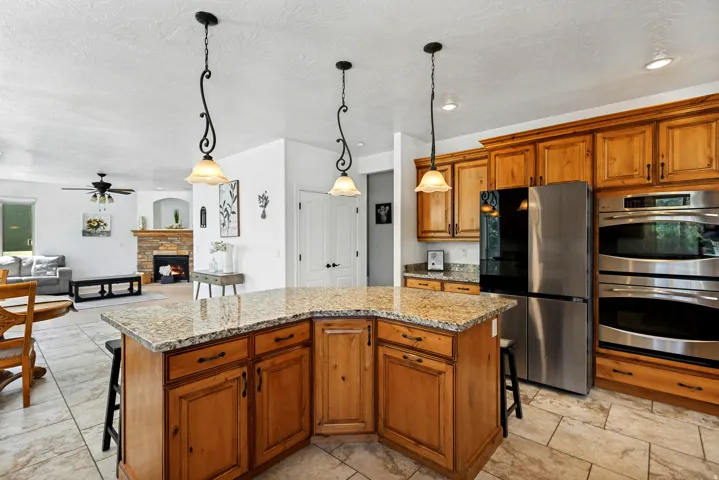 Kitchen island with granite countertop and pendant lighting