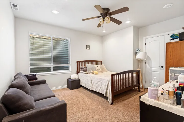 Recessed lighting, ceiling fan with light fixture, white interior door, and light-colored carpet flooring