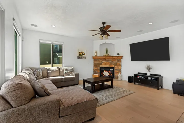 Corner fireplace with a stone surround and wood mantel