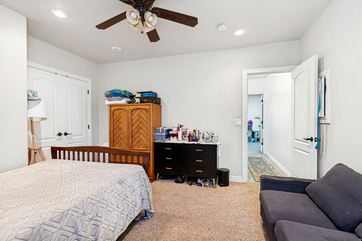 Recessed lighting, ceiling fan, carpet flooring, and white interior doors