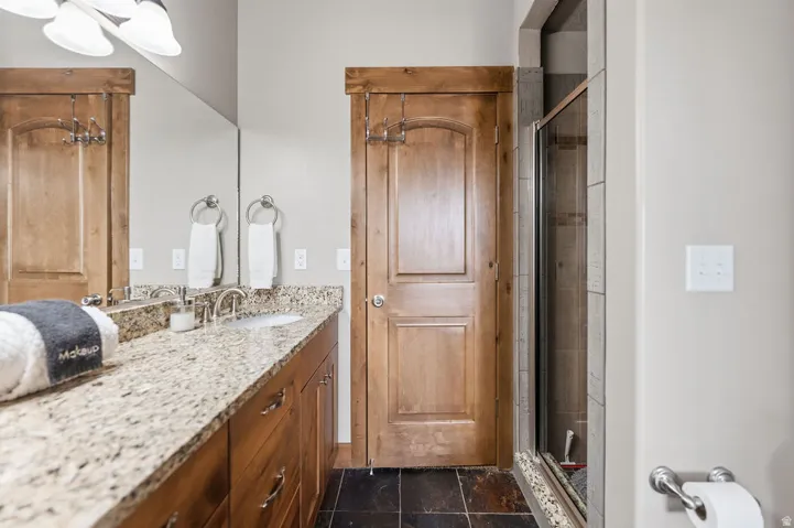 Wood-finish vanity with a light-toned countertop and integrated sink