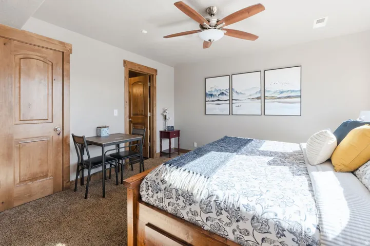 Wood-finish ceiling fan with integrated lighting, wood-finish interior doors, and neutral wall paint