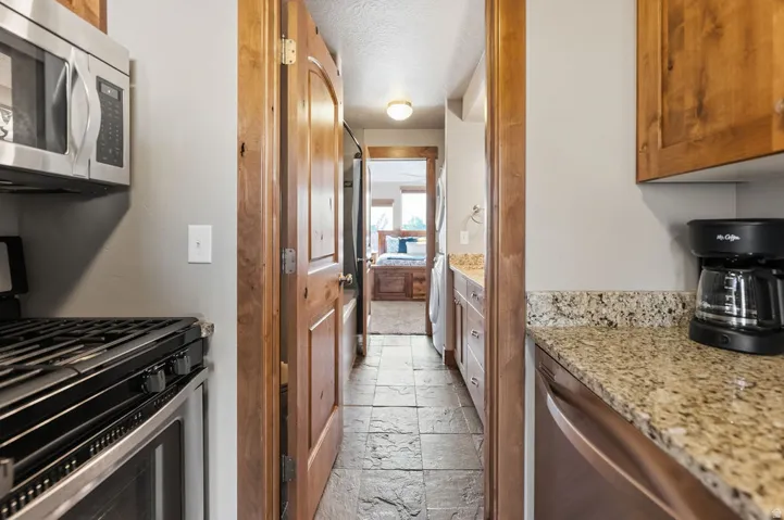 Stainless steel microwave, gas range with oven, and dishwasher