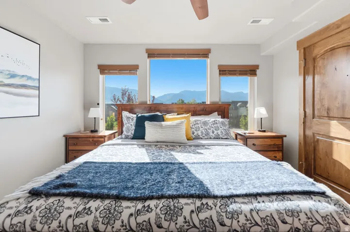 Recessed lighting, wood-finish ceiling fan, wood-finish window blinds, and a wood-finish door