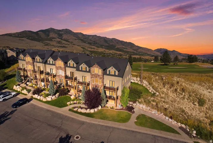 Multi-story residences featuring stone and siding exteriors, private balconies, and dormer windows