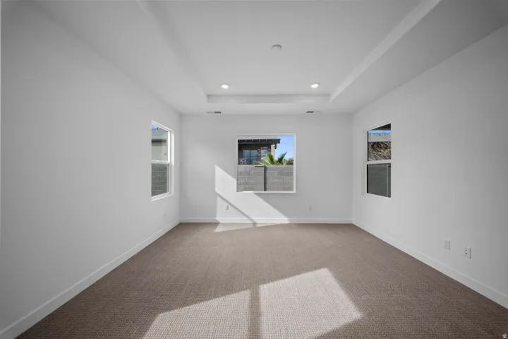 Recessed lighting illuminates a tray ceiling