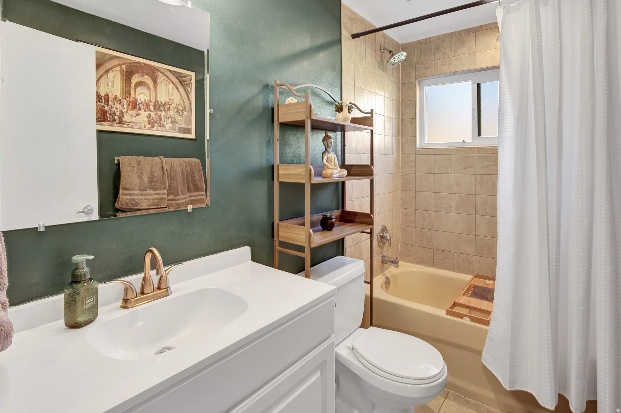 White vanity with integrated sink, bronze-finish faucet, and coordinating mirror