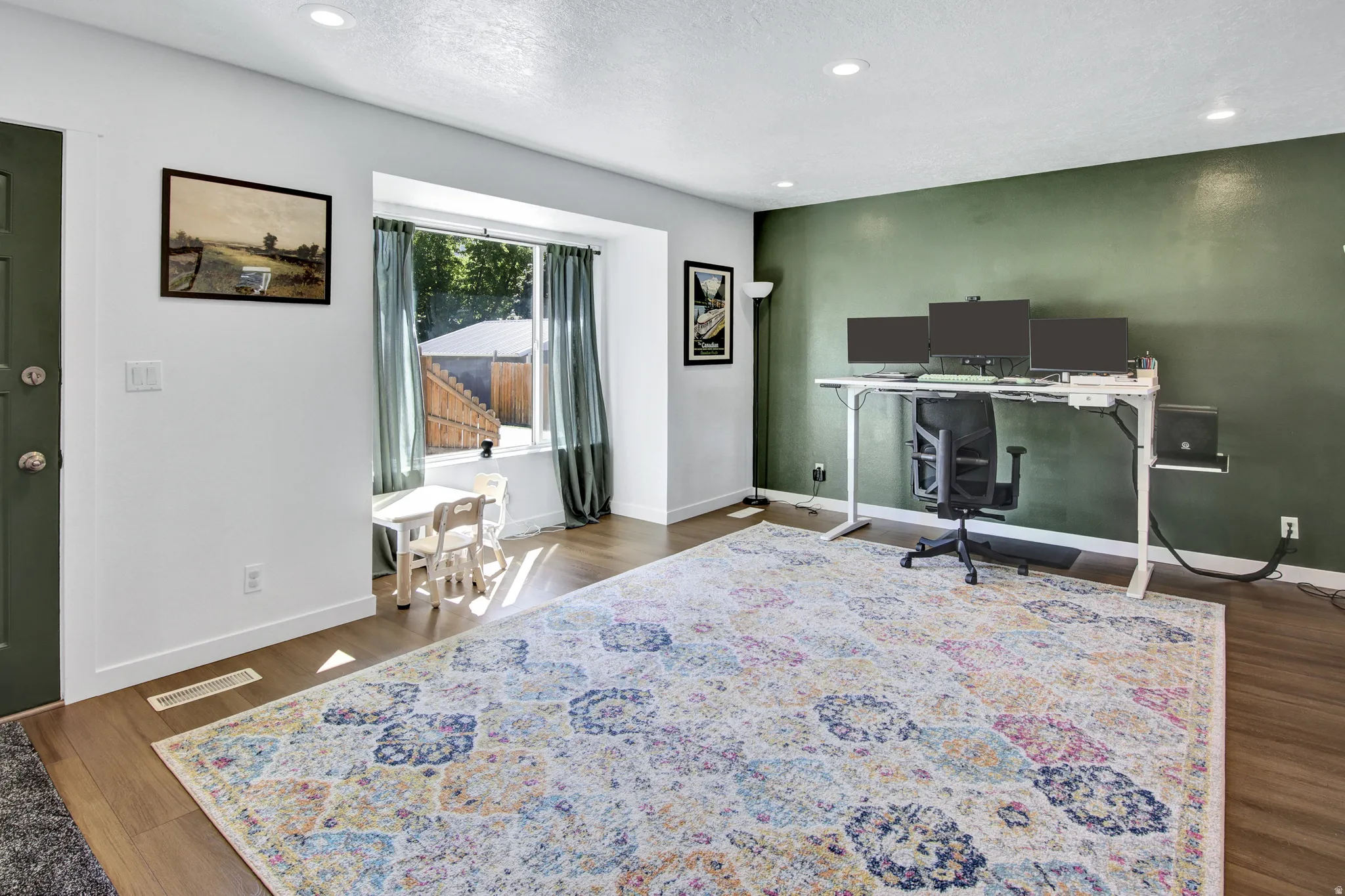 Recessed lighting illuminates wood-finish flooring