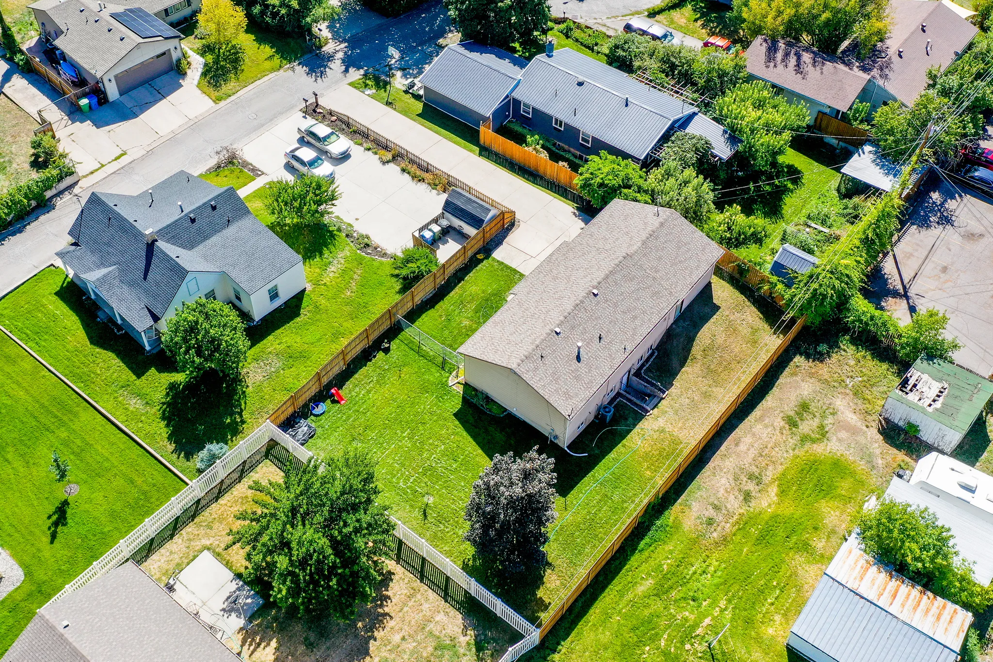 Expansive lot featuring a residential structure with a light-colored roof
