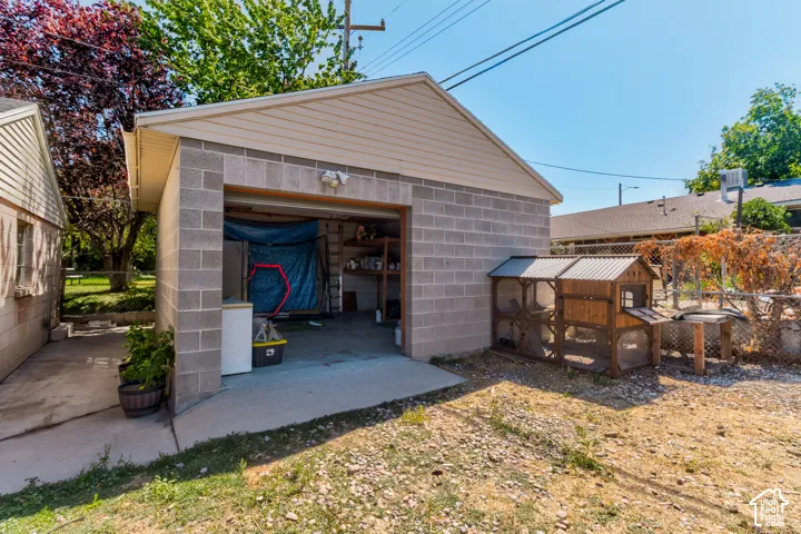 Detached garage with concrete block construction and a gable roof