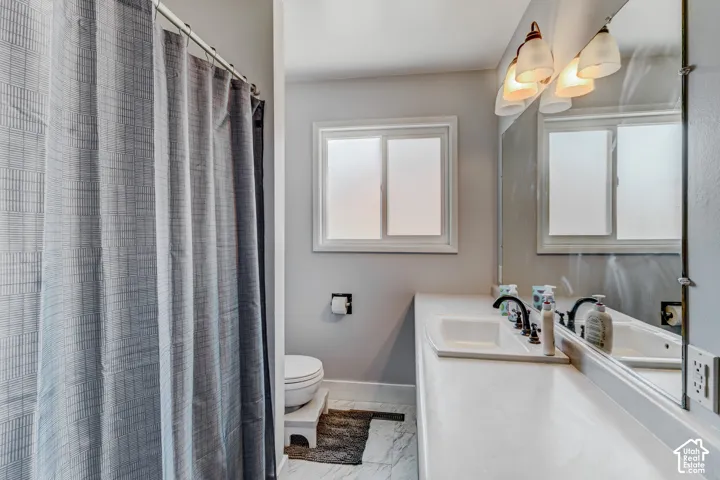 Dual-sink vanity with dark-finish faucets and an integrated countertop