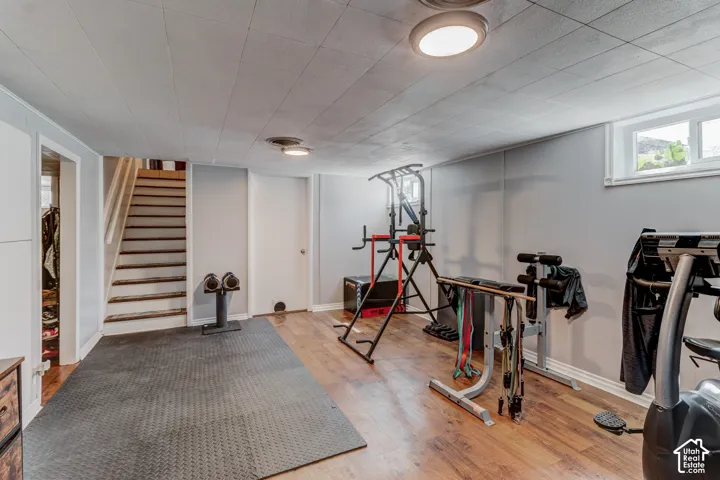 Finished lower level featuring recessed lighting, wood-finish flooring, and a window