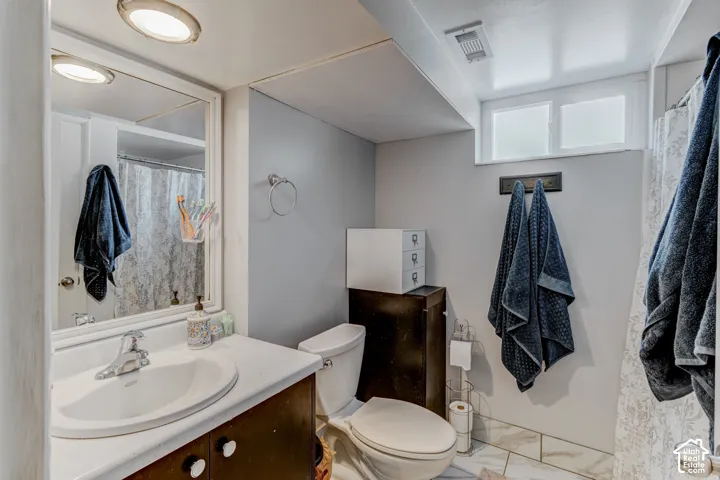 Built-in vanity with a white countertop and integrated sink