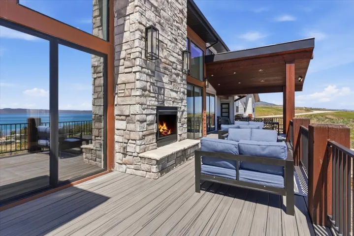Spacious deck with stone-clad fireplace and wood-finish ceiling