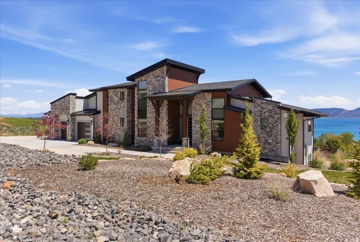 Contemporary architectural design featuring stone and wood-finish siding