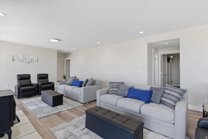 Spacious common area featuring recessed lighting, wood-finish flooring, and light-toned wall finishes