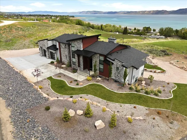 Contemporary exterior featuring stone accents and dark trim